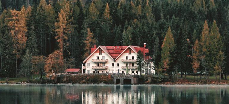 white and red house near lake